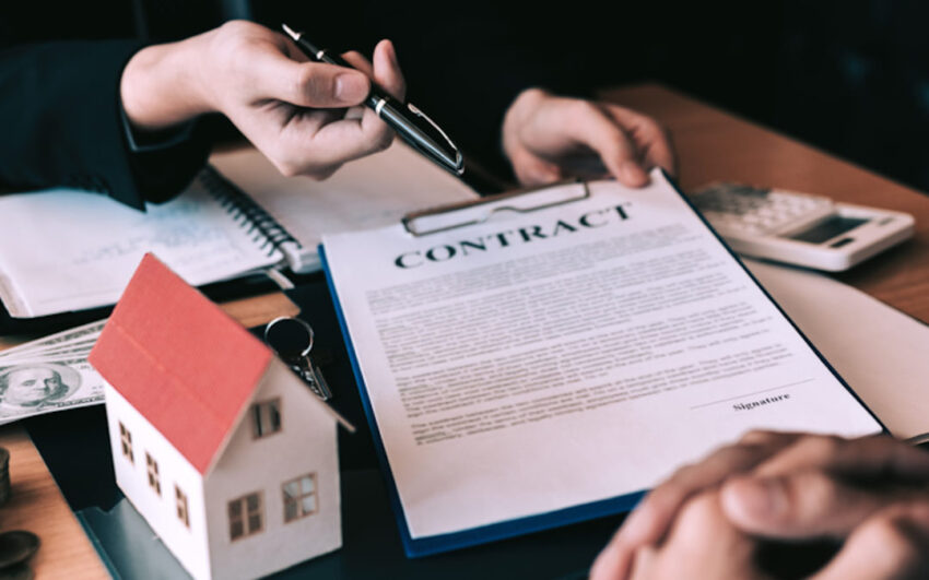 Hands holding a contract to buying a home.